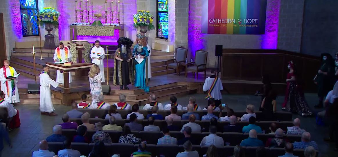 photo of a baptism ceremony for drag queens inside a Texas church