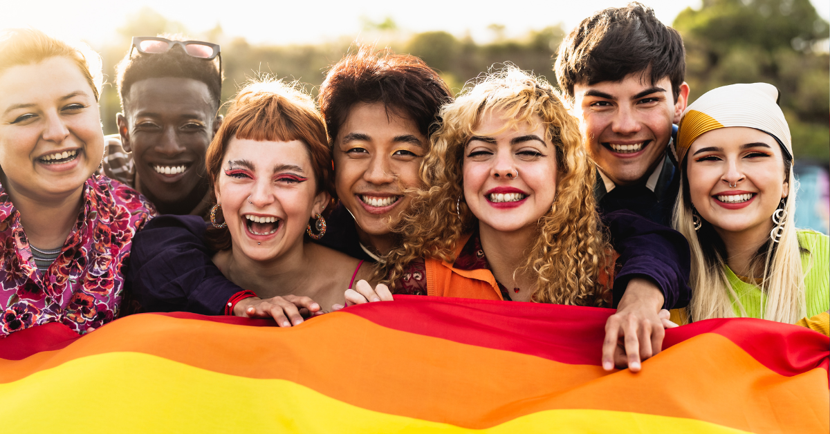 young lgbt people holding an lgbt flag